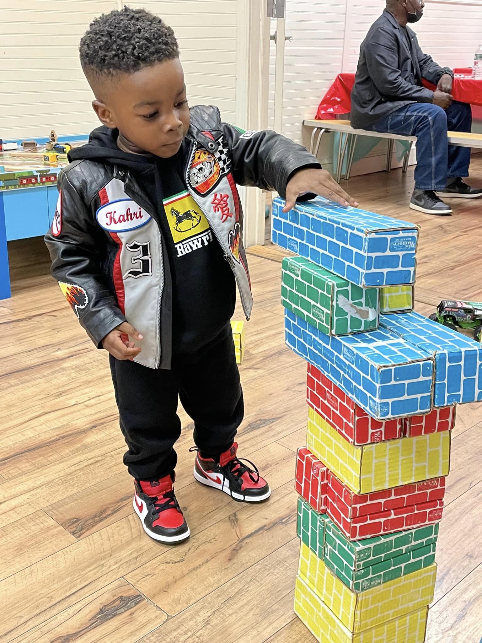 Young boy playing building blocks at party in Rockville Centre